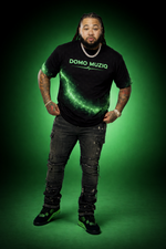 Person wearing a black t-shirt with 'DOMO MUZIQ' text on a green background
